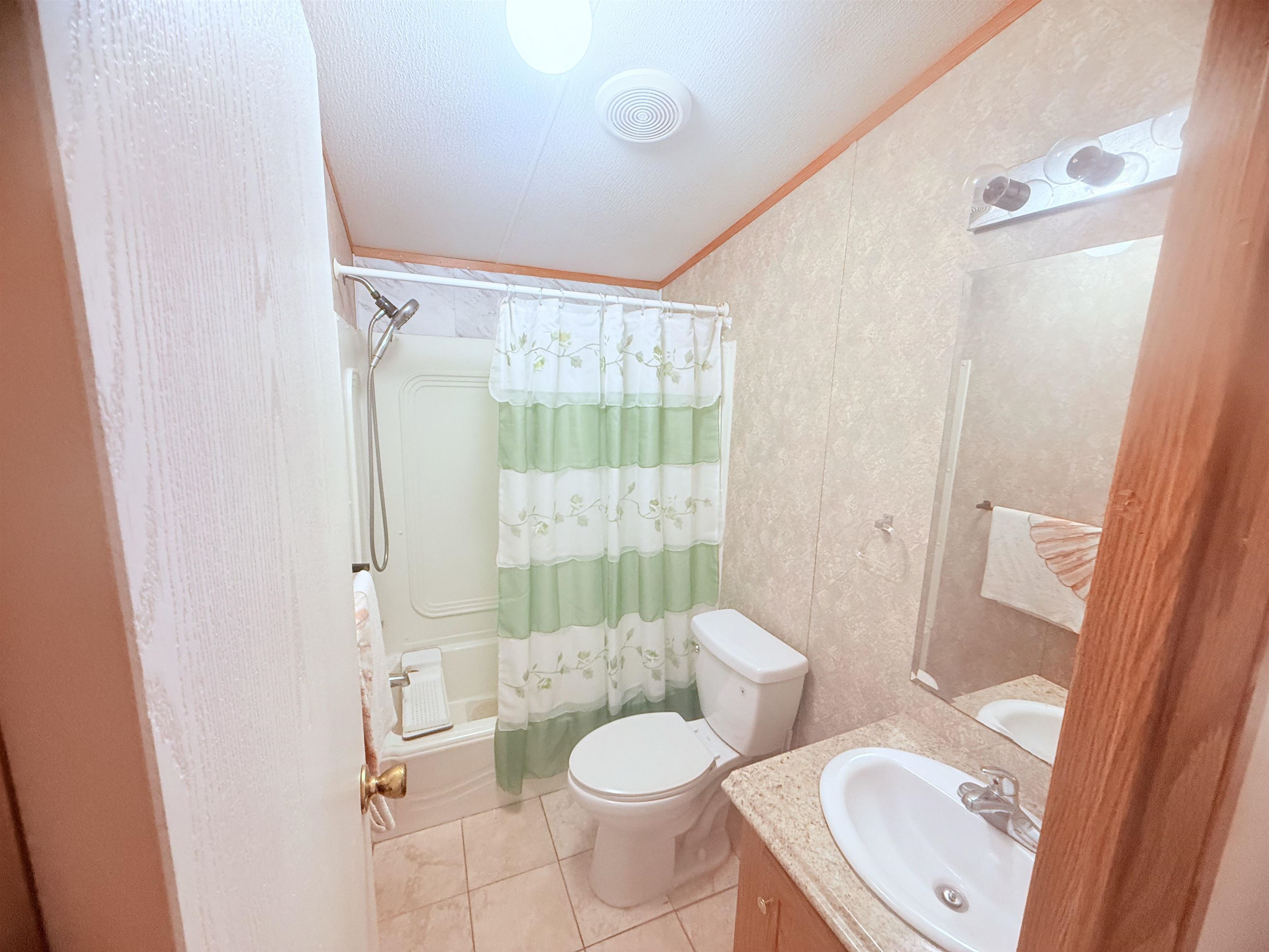 5 Buccaneer Street Murrells Inlet, SC 29576 - Photo 21 of 30 Bathroom featuring shower / bath combo with shower curtain, vanity, ornamental molding, light tile patterned flooring, and wallpapered walls