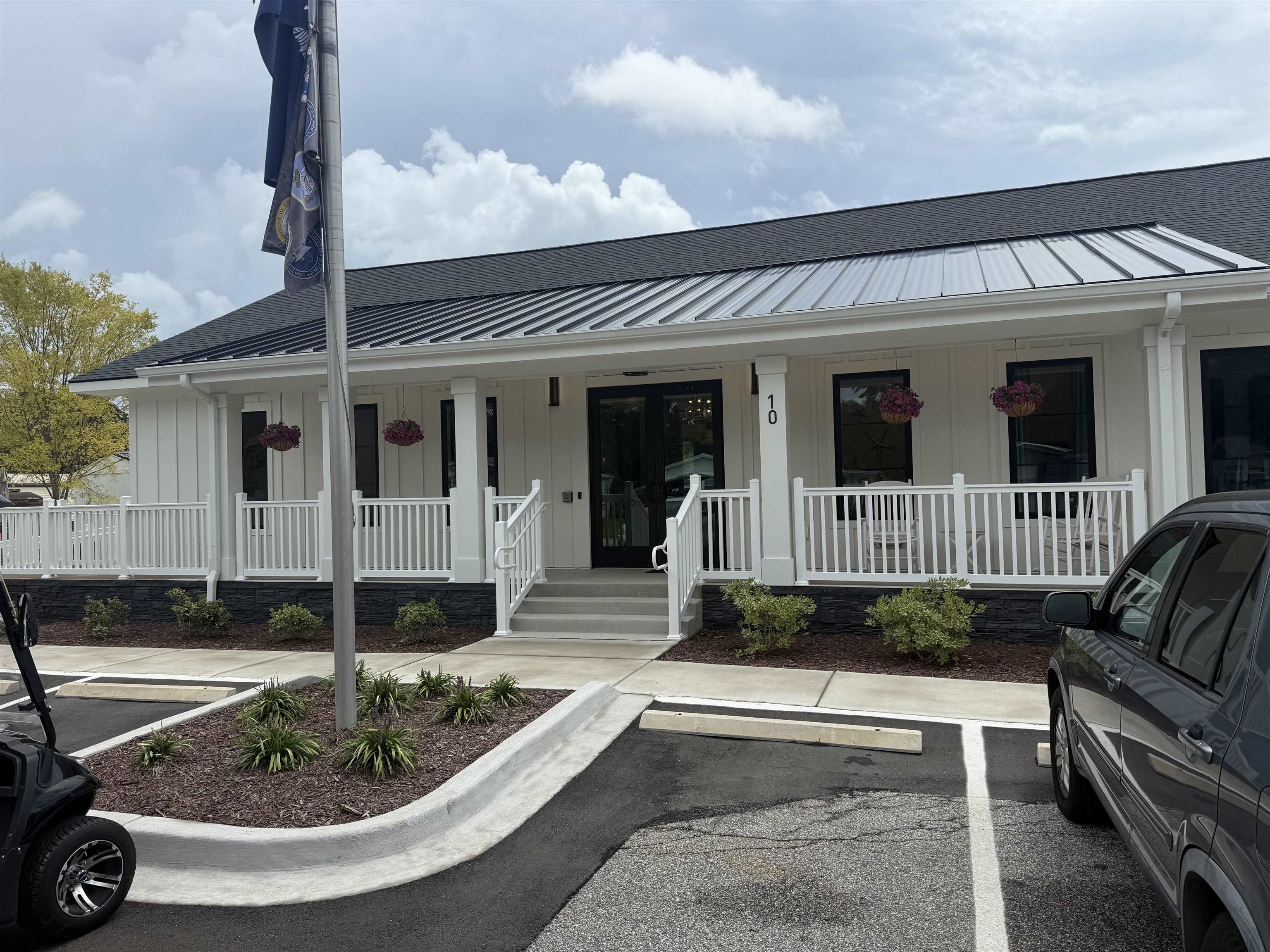 5 Buccaneer Street Murrells Inlet, SC 29576 - Photo 26 of 30 View of front of house with board and batten siding, covered porch, uncovered parking, and a shingled roof