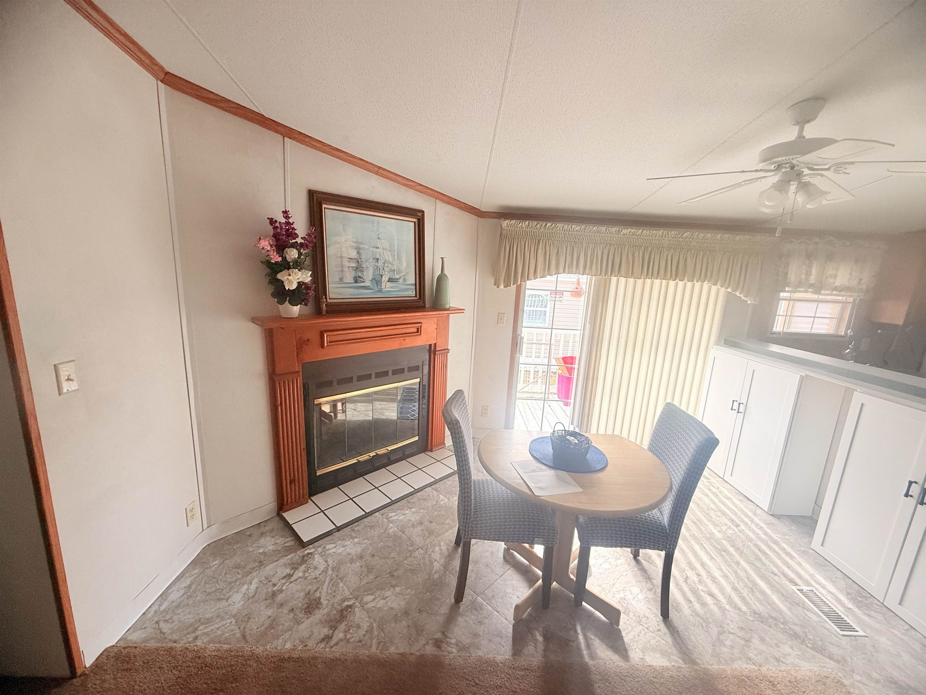 5 Buccaneer Street Murrells Inlet, SC 29576 - Photo 9 of 30 Dining room featuring a glass covered fireplace, ornamental molding, and ceiling fan