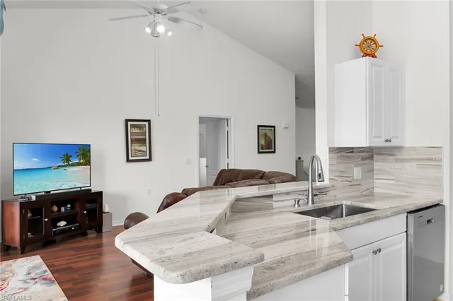 a kitchen with stainless steel appliances a stove sink microwave and cabinets