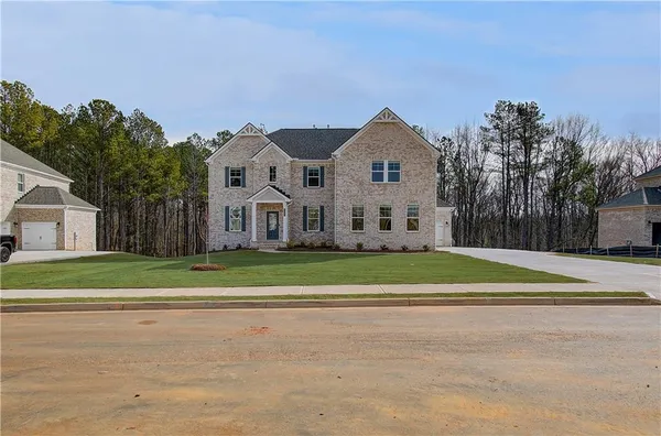 a front view of a house with a yard