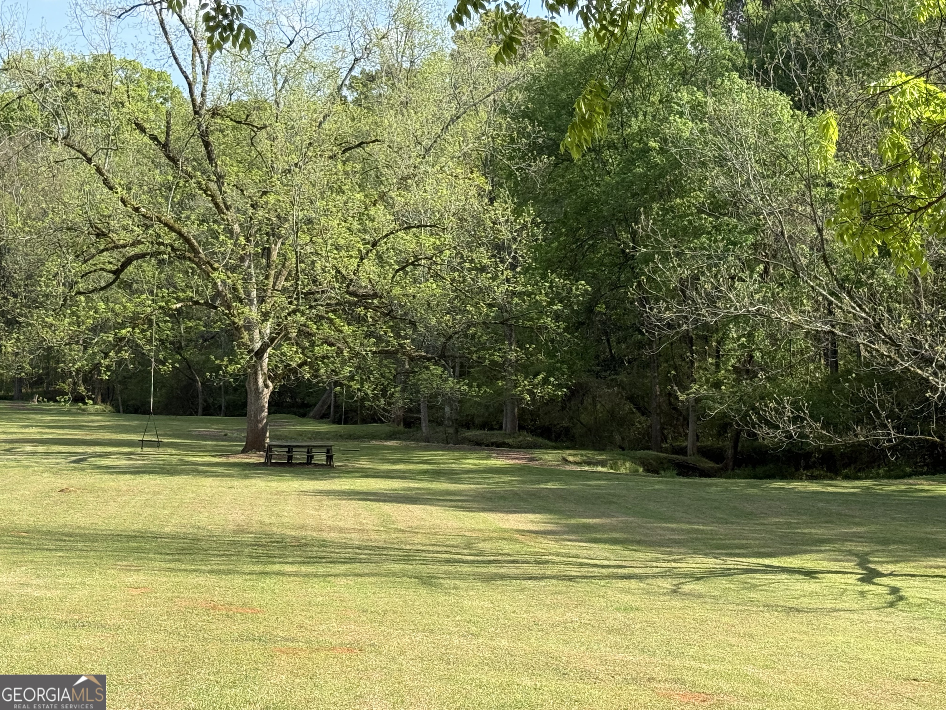 533 Village Road Madison, GA 30650 - Photo 6 of 6 a view of a swimming pool with an outdoor space and seating area