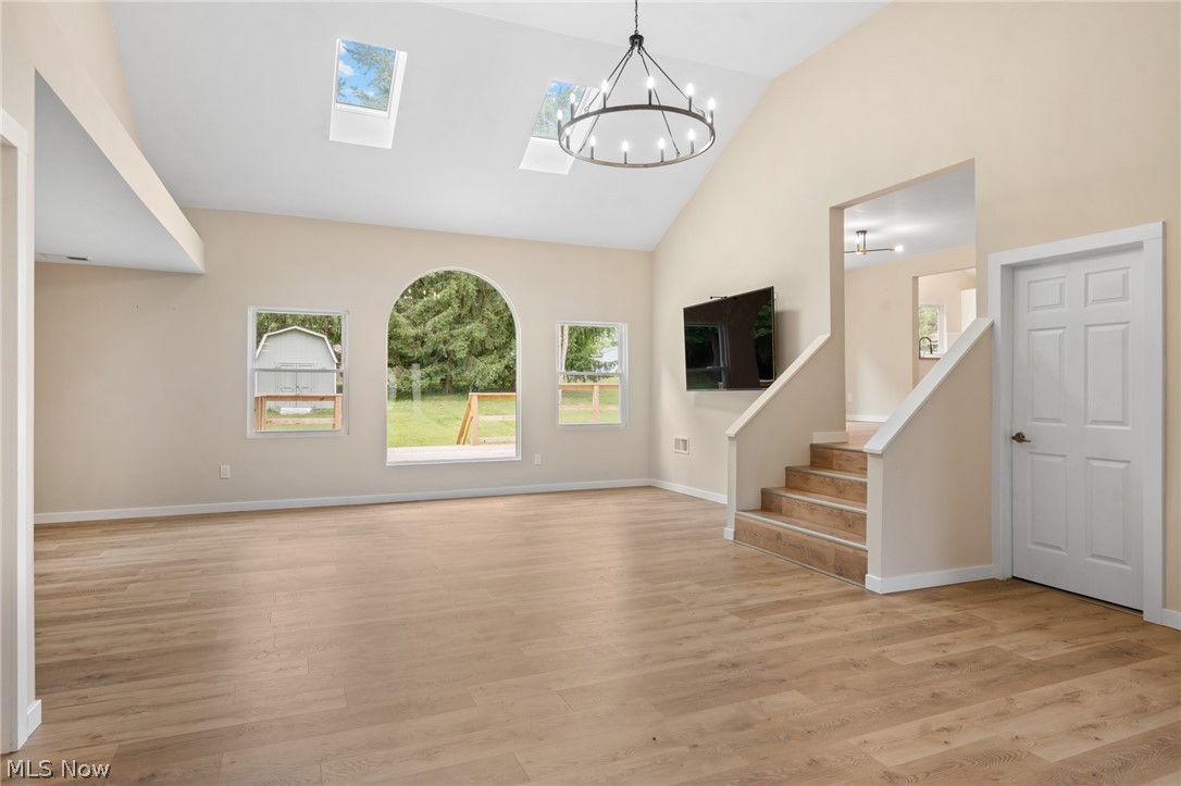 1617 Graham Road Stow, OH 44224 - Photo 9 of 49 Entrance foyer with a skylight, light hardwood / wood-style flooring, and an inviting chandelier