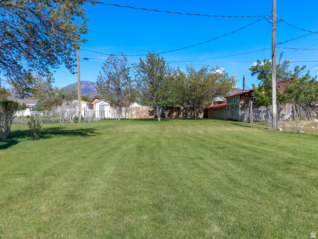 155 West Center Street Fillmore, UT 84631 - Photo 75 of 86 Expansive green lawn with mature trees and a distant mountain backdrop