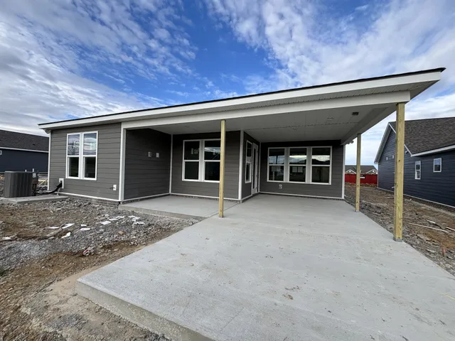 a living room with furniture and a lamp