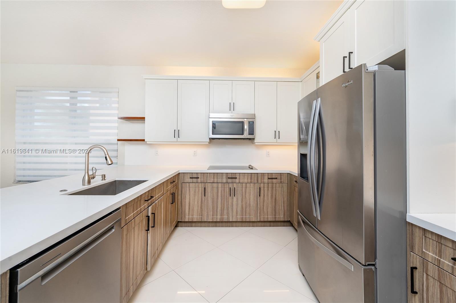 4136 Southwest 179th Way Miramar, FL 33029 - Photo 11 of 42 a kitchen with stainless steel appliances granite countertop a refrigerator sink and stove