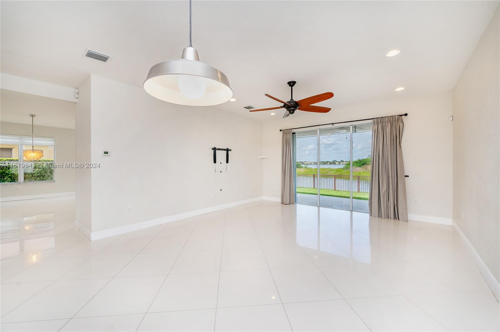 4136 Southwest 179th Way Miramar, FL 33029 - Photo 16 of 42 a view of an empty room with a fireplace and a dining table