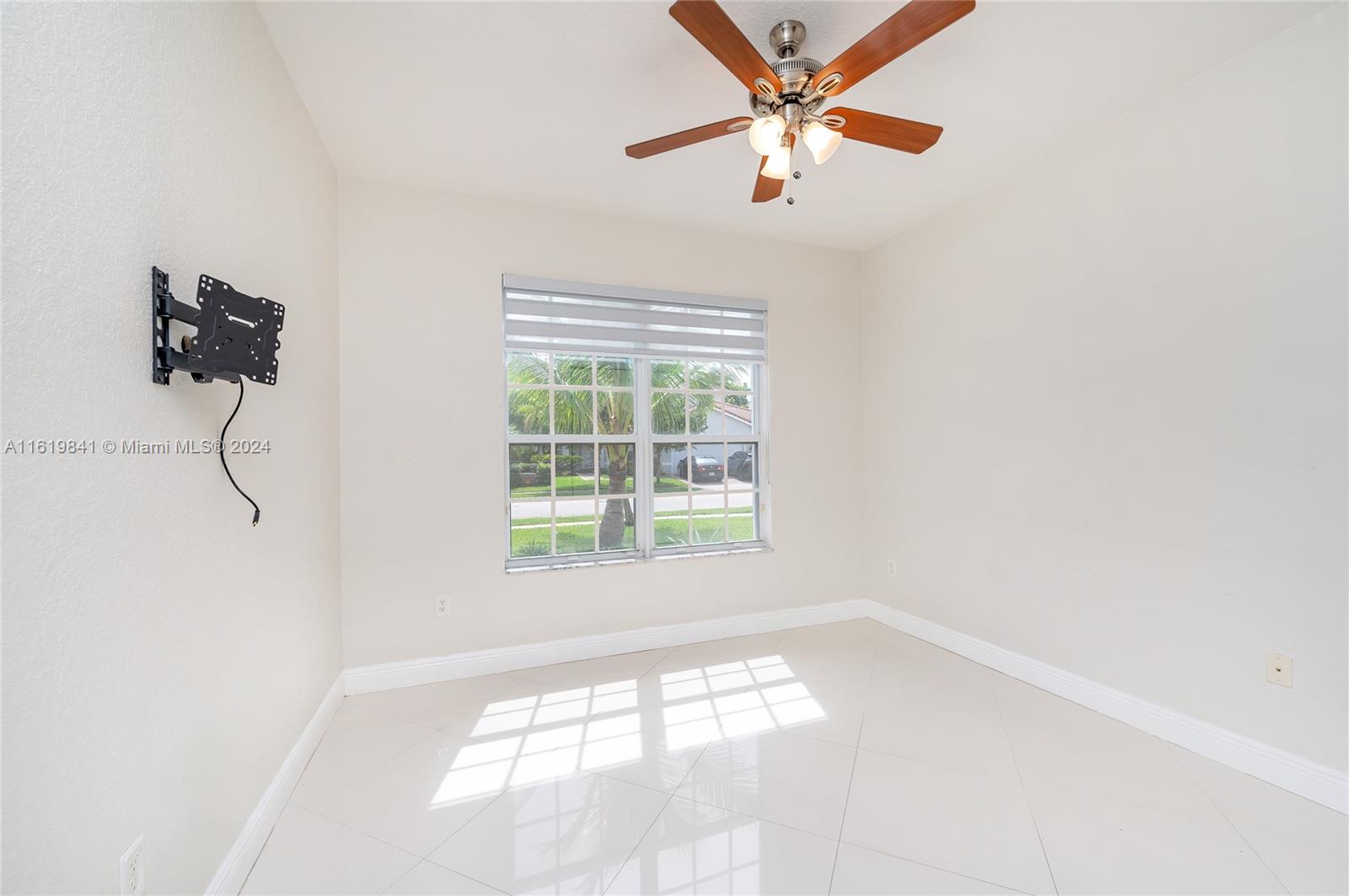 4136 Southwest 179th Way Miramar, FL 33029 - Photo 17 of 42 an empty room with a window and a fan