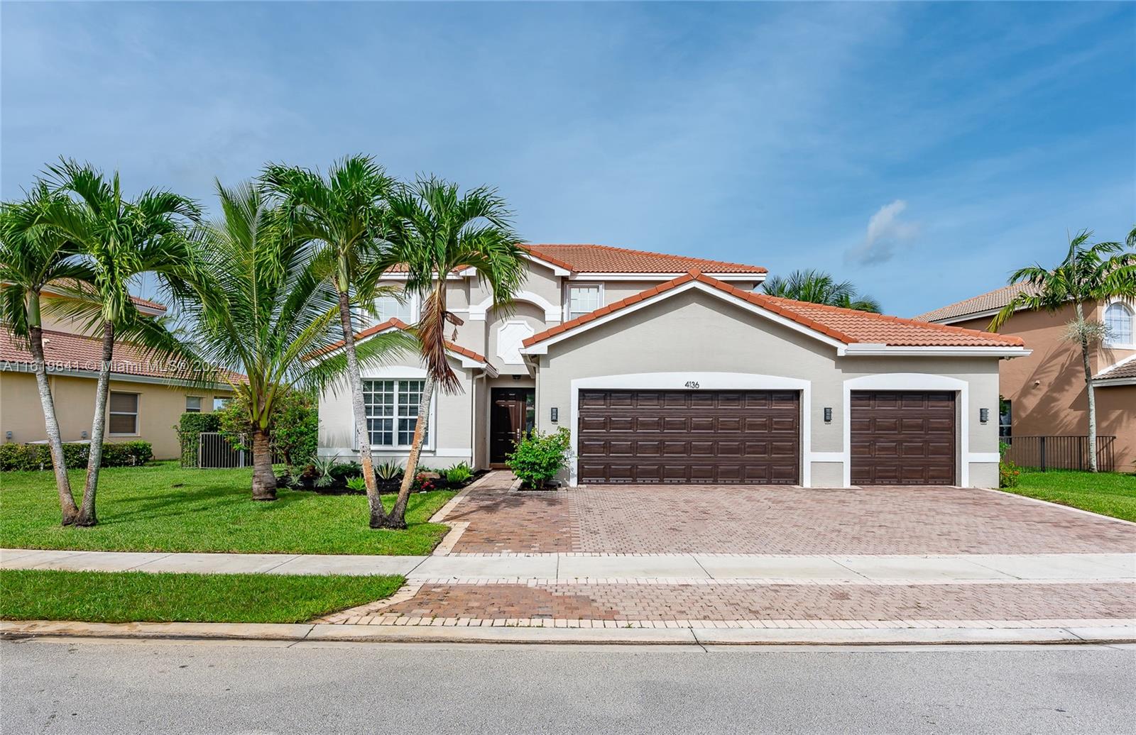 4136 Southwest 179th Way Miramar, FL 33029 - Photo 2 of 42 a front view of a house with a yard and garage