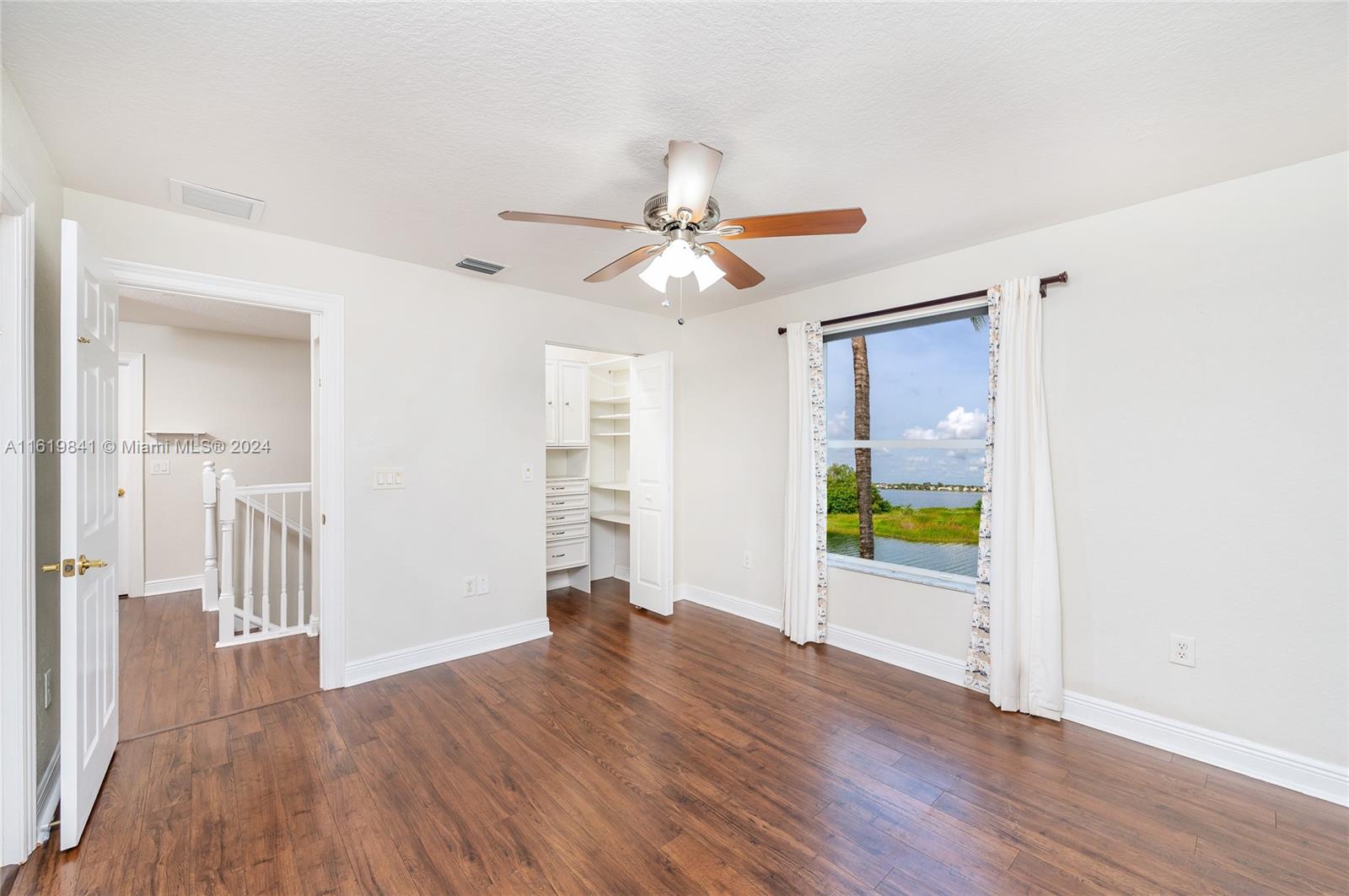 4136 Southwest 179th Way Miramar, FL 33029 - Photo 27 of 42 a view of a livingroom with wooden floor a ceiling fan and a window