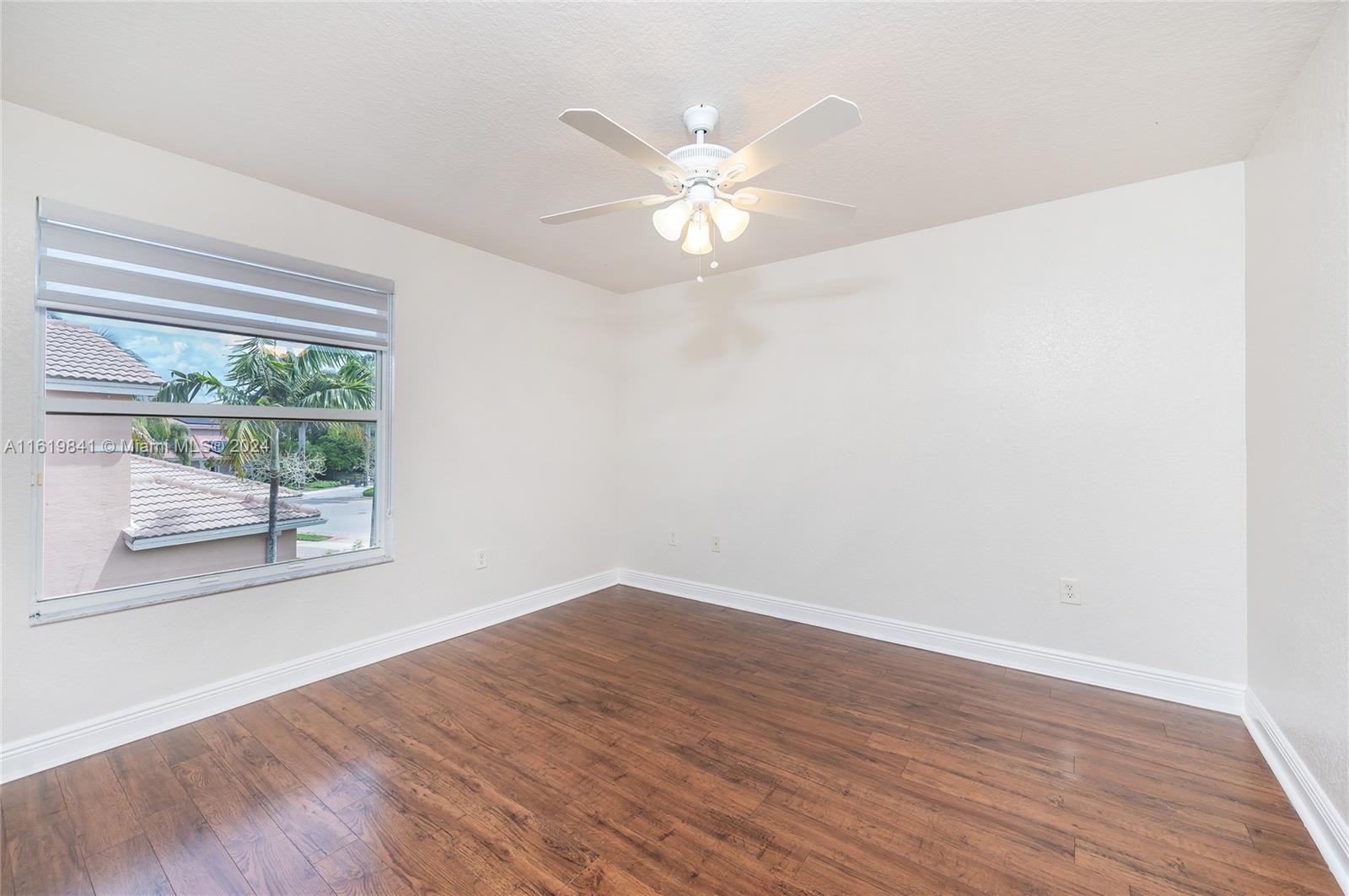 4136 Southwest 179th Way Miramar, FL 33029 - Photo 31 of 42 wooden floor in an empty room with a window