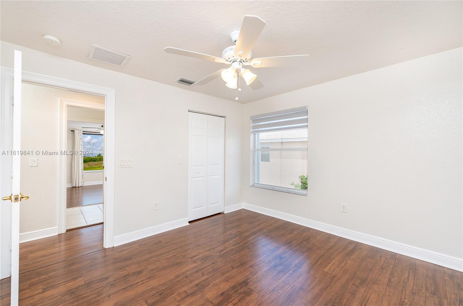 4136 Southwest 179th Way Miramar, FL 33029 - Photo 32 of 42 a view of an empty room with wooden floor and a window