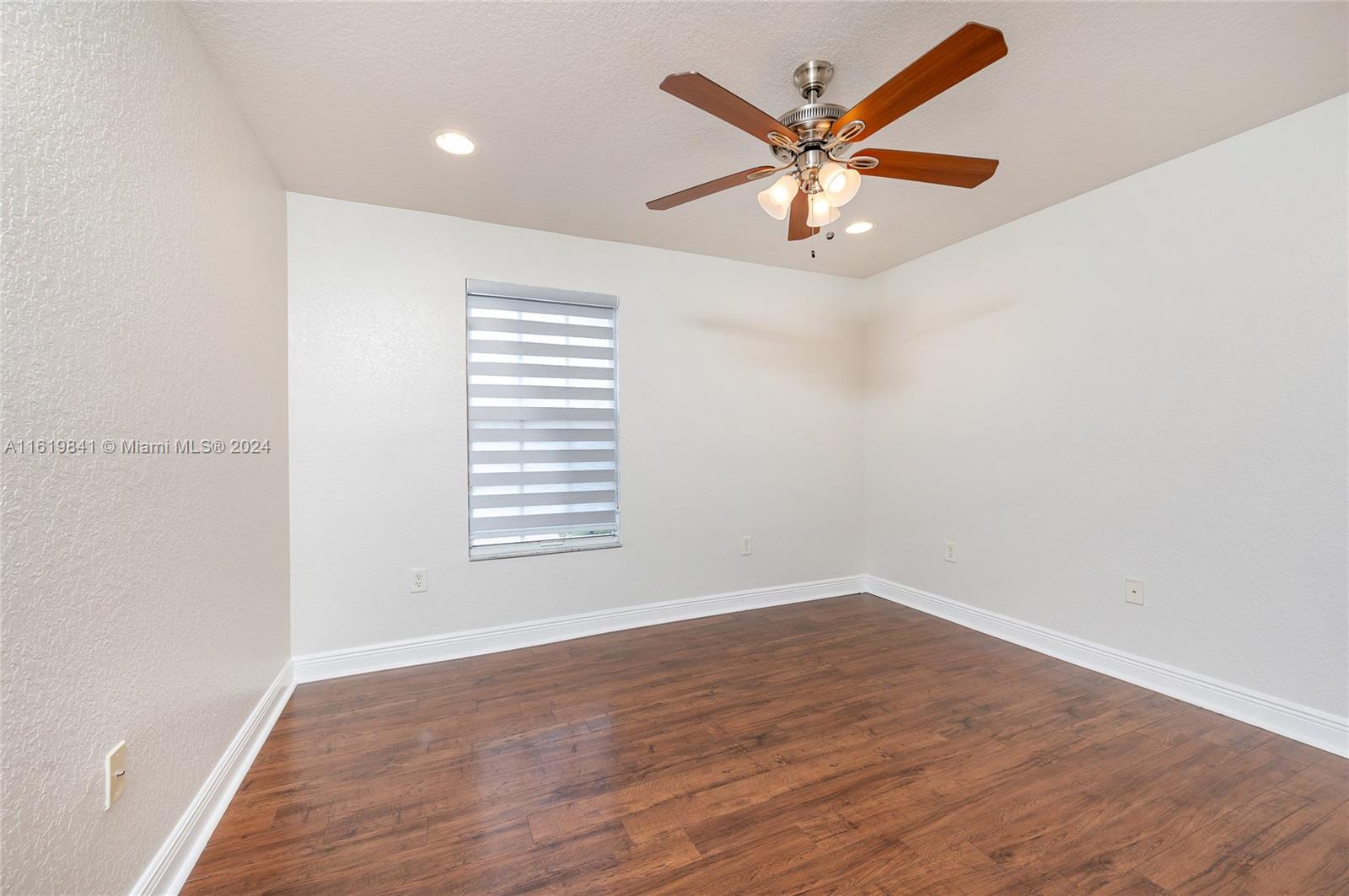 4136 Southwest 179th Way Miramar, FL 33029 - Photo 34 of 42 an empty room with wooden floor and windows