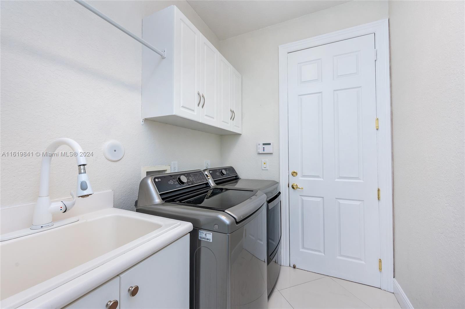 4136 Southwest 179th Way Miramar, FL 33029 - Photo 41 of 42 a kitchen with white cabinets and sink