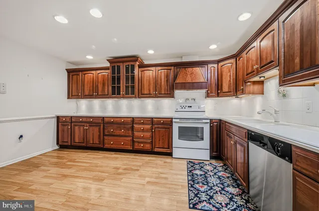 a kitchen with a stove top oven sink and cabinets