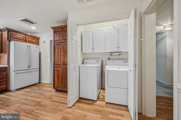 a view of a kitchen with refrigerator and cabinet