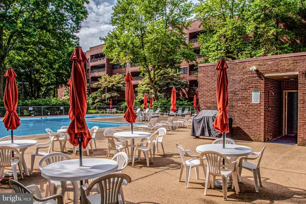 a view of a patio with a table and chairs and potted plants