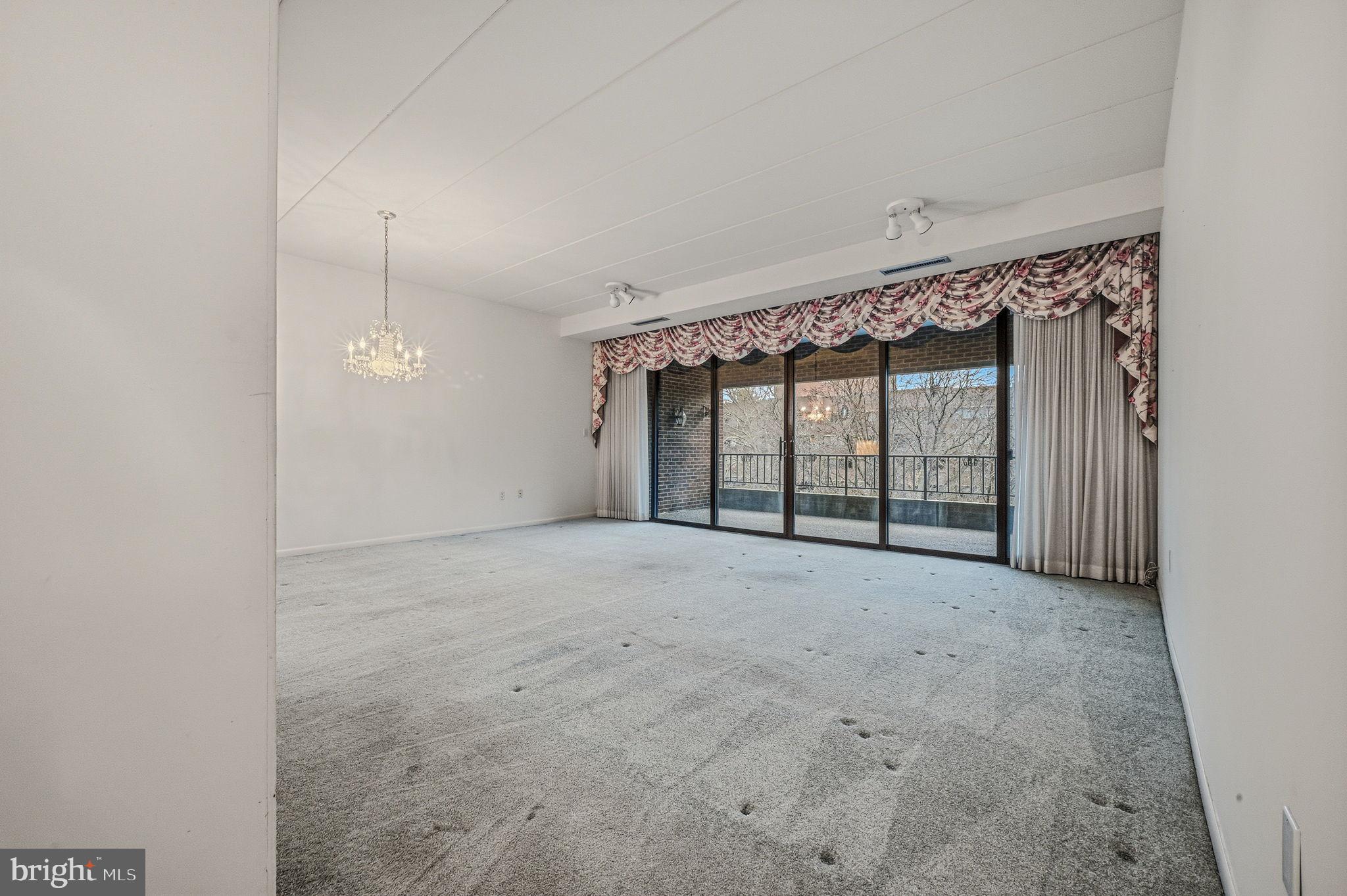 614 Loveville Road, Unit D5F Hockessin, DE 19707 - Photo 7 of 25 an empty room with windows and ceiling fan