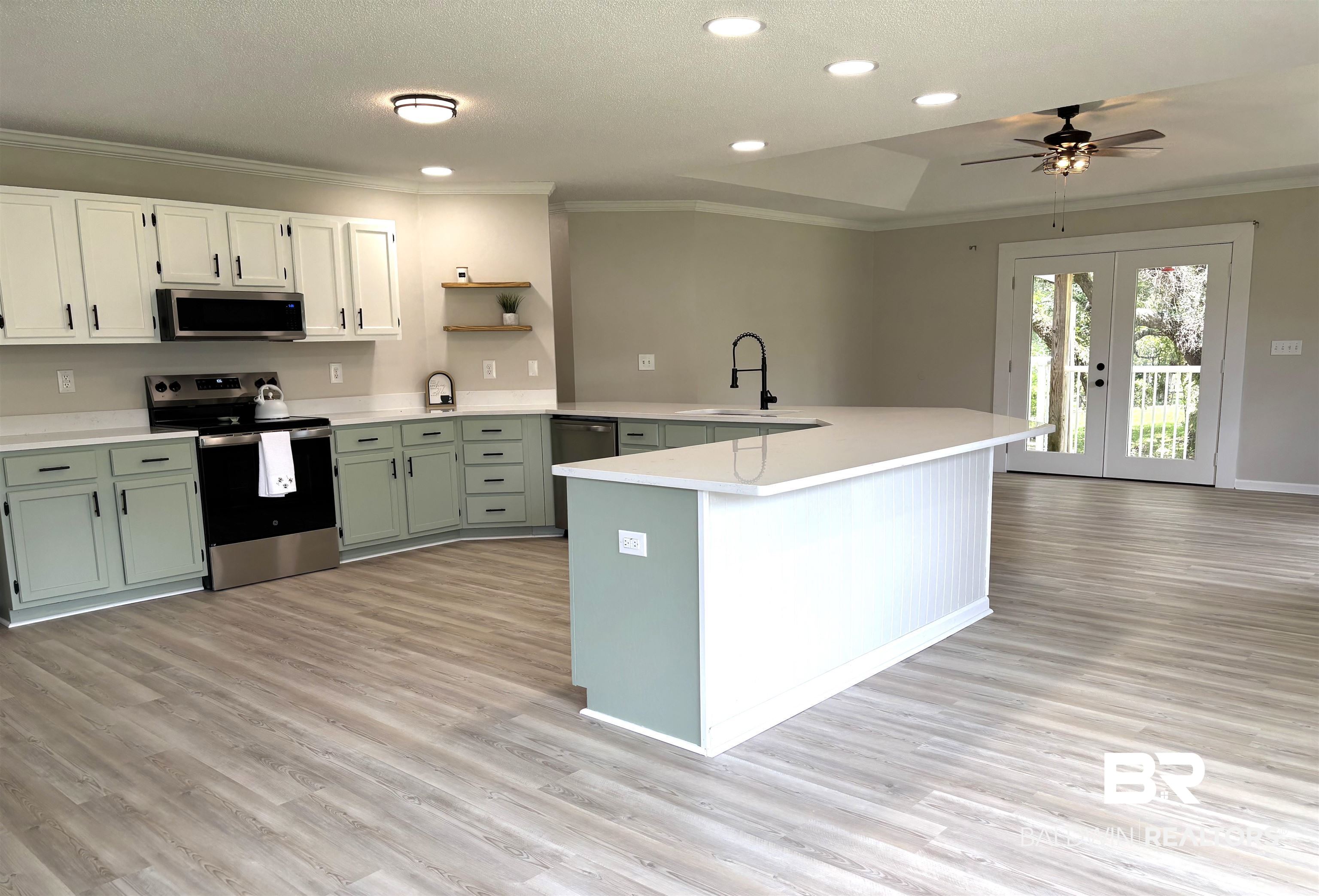 35650 Spring Road North Stapleton, AL 36578 - Photo 23 of 70 Kitchen featuring crown molding, appliances with stainless steel finishes, green cabinets, a peninsula, and open shelves