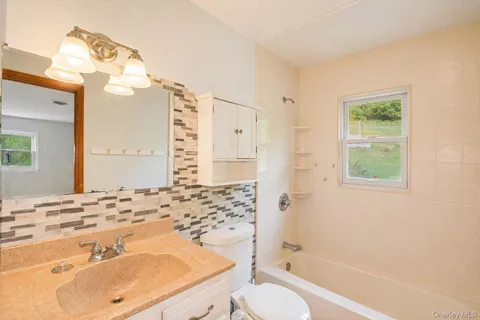 a bathroom with a sink toilet tub and shower
