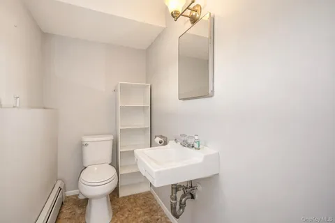 a white toilet sitting next to a bathroom sink