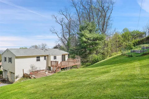 a view of a house with a yard and sitting area
