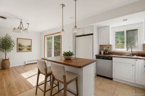 a kitchen with stainless steel appliances granite countertop a kitchen island a stove and a sink
