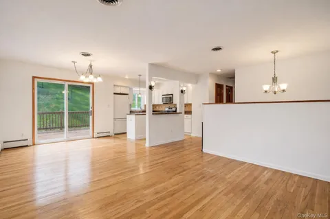 a view of a kitchen with wooden floor and a kitchen