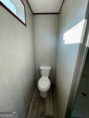 a white toilet sitting in a bathroom