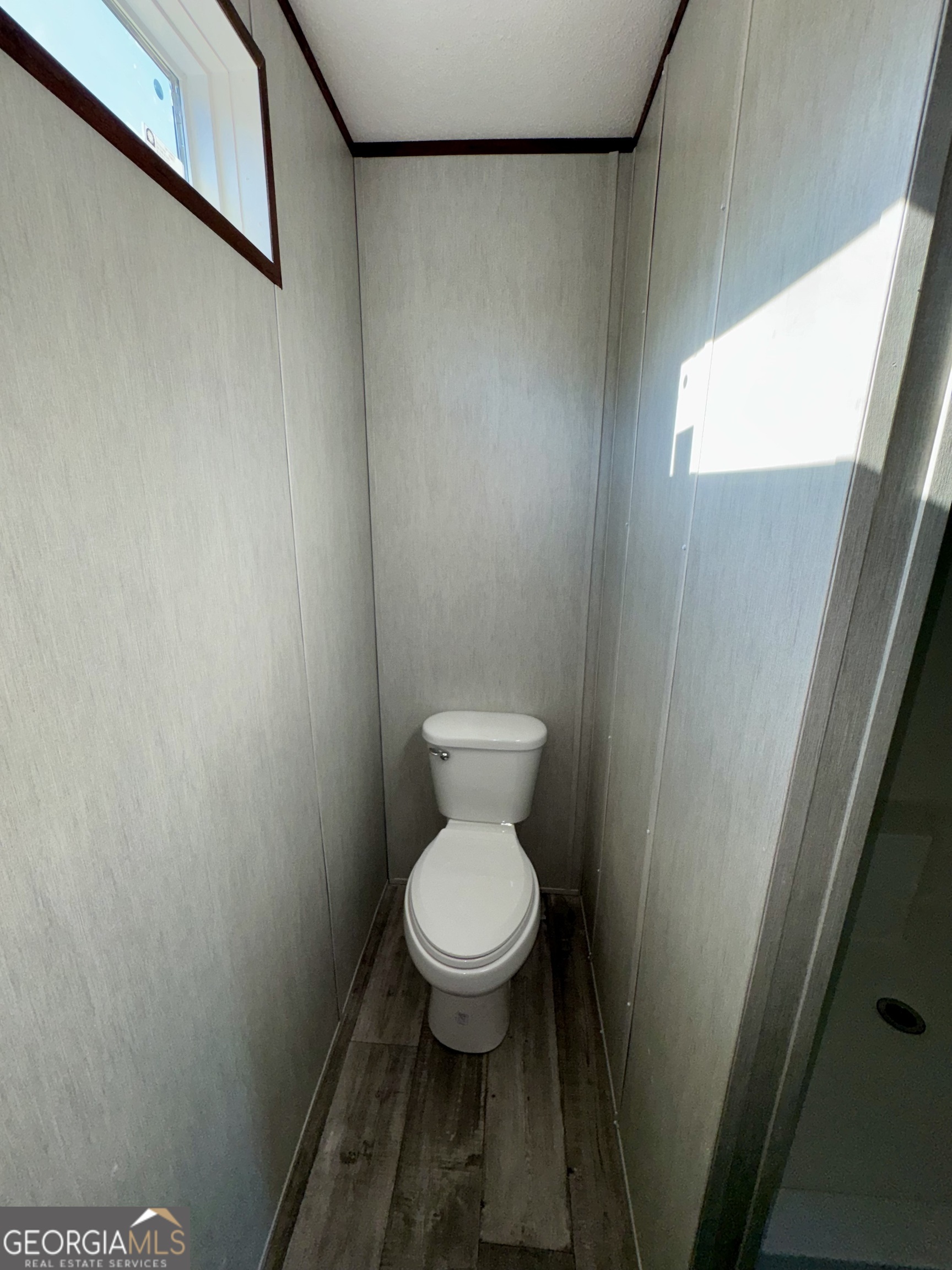 545 Ben Jackson Road Vidalia, GA 30474 - Photo 13 of 25 a white toilet sitting in a bathroom