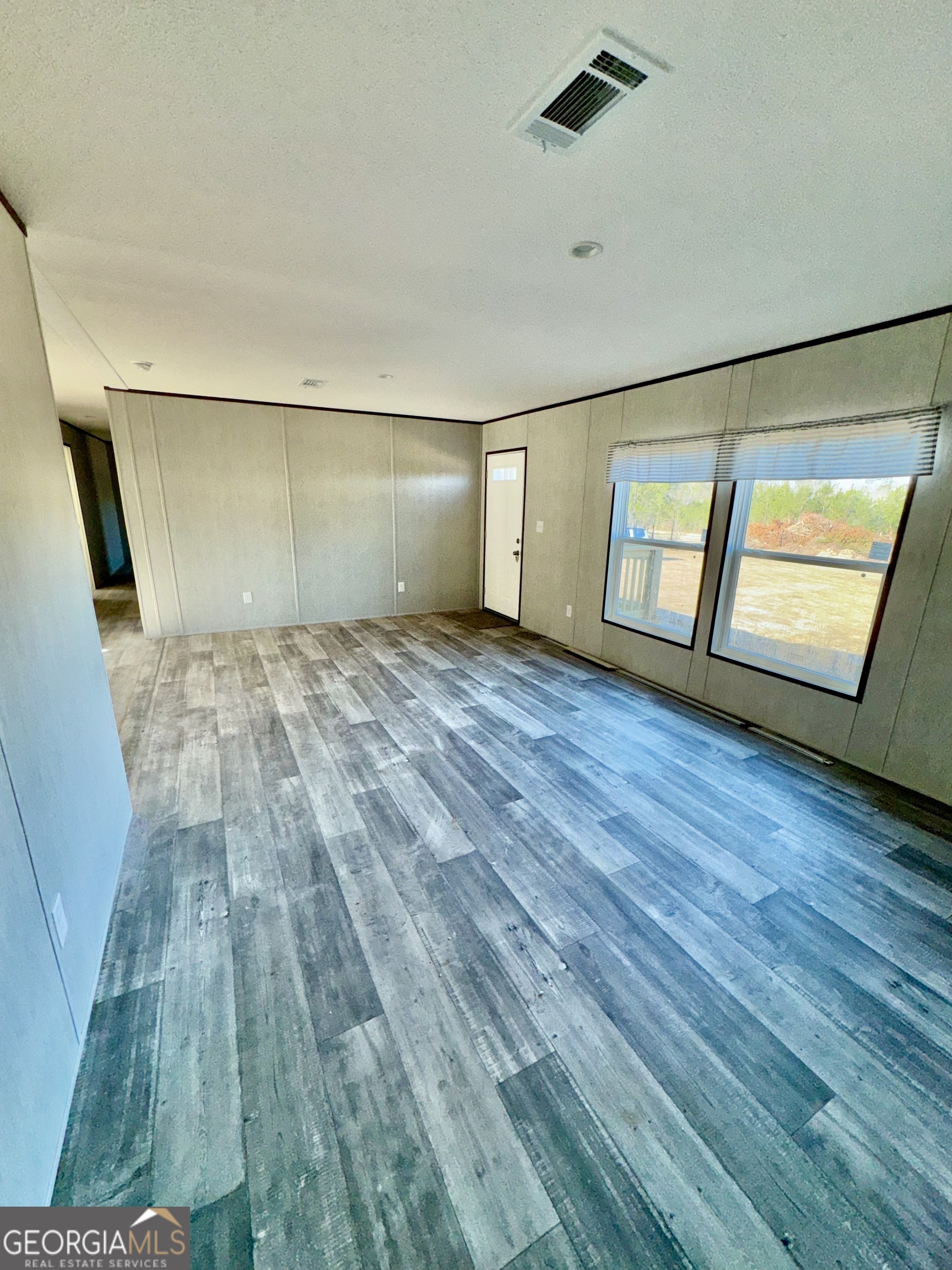 545 Ben Jackson Road Vidalia, GA 30474 - Photo 15 of 25 a view of empty room with wooden floor and fan