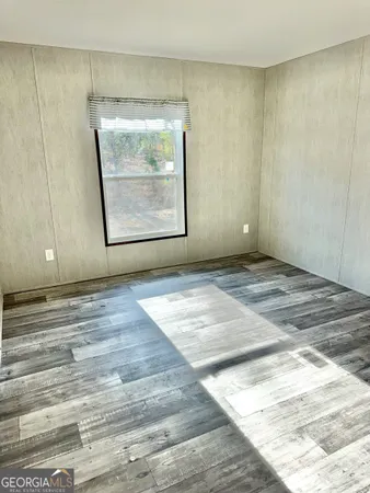 a view of room with window and hardwood floor