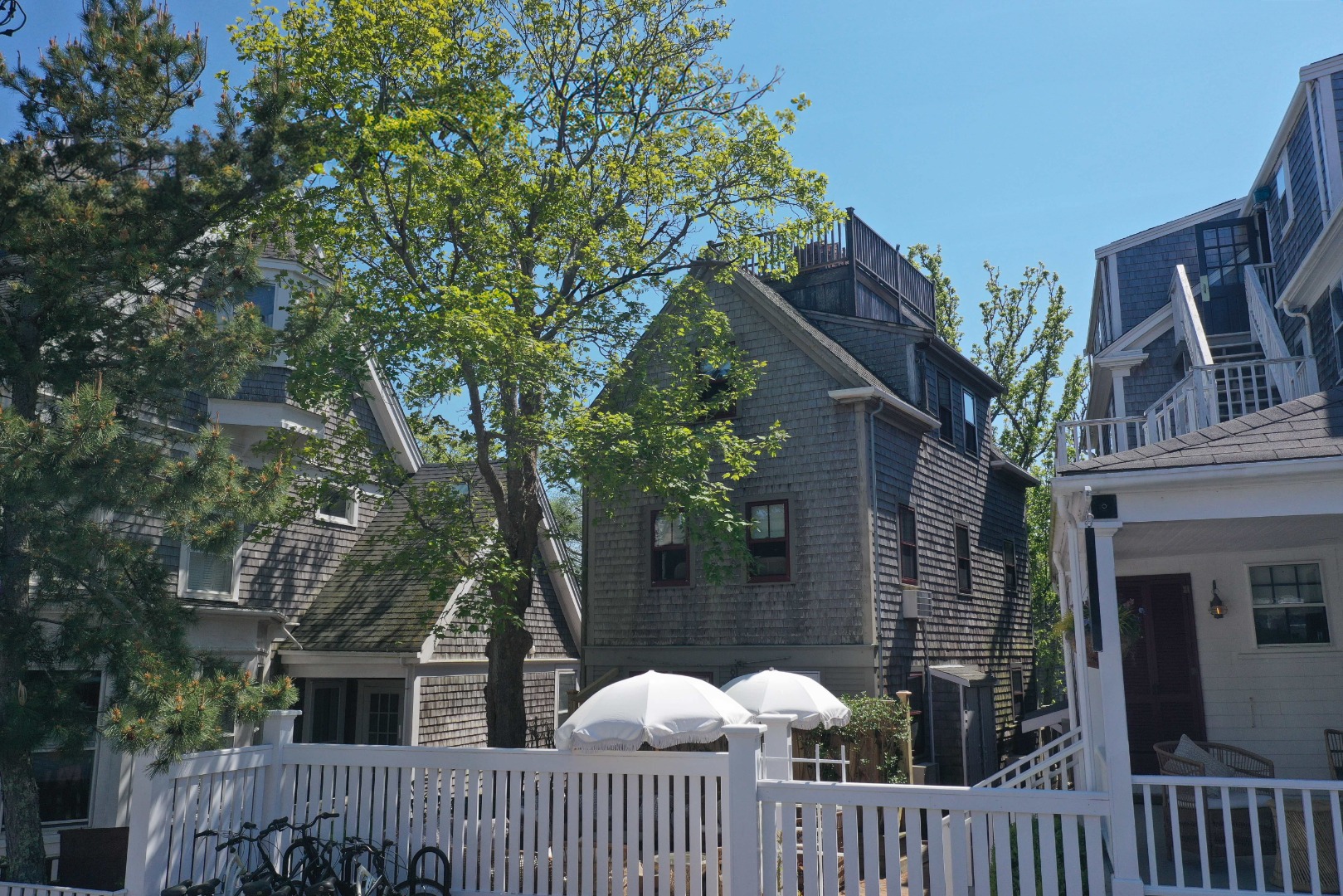 10 A Cliff Road Nantucket, MA 02554 - Photo 2 of 16 a view of a house with a small yard and wooden fence