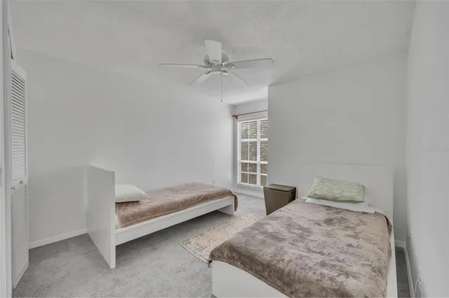 a bedroom with two beds and window