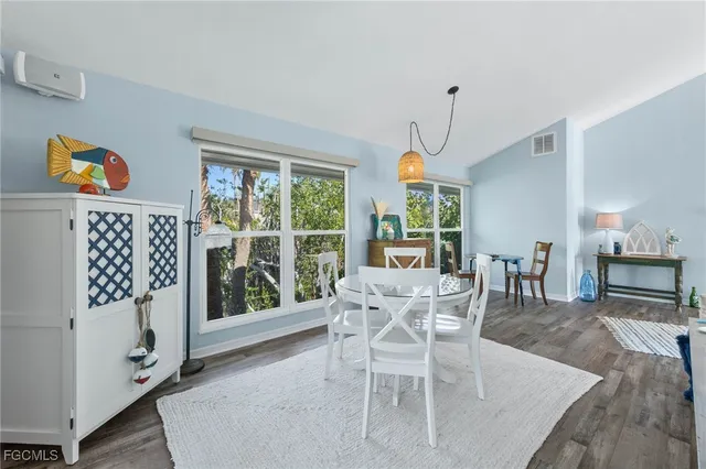 a dining room with furniture a window and wooden floor