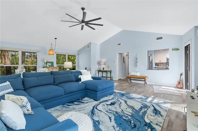 a view of a room with wooden floor and a couch