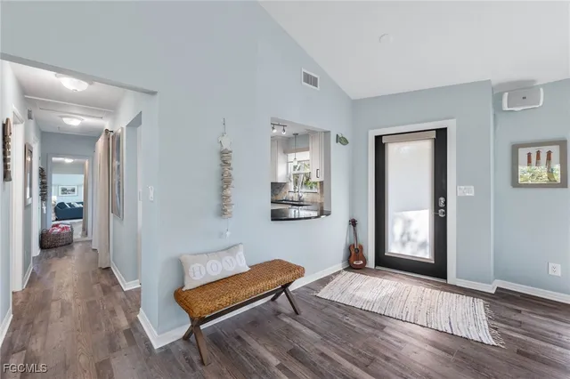a kitchen with granite countertop white cabinets white appliances and sink
