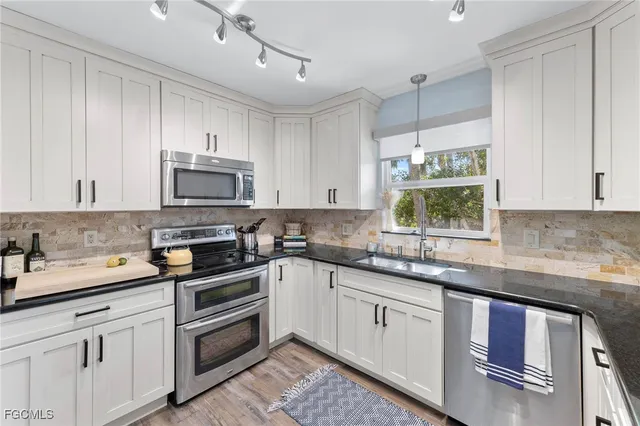 a kitchen with stainless steel appliances a refrigerator stove and microwave