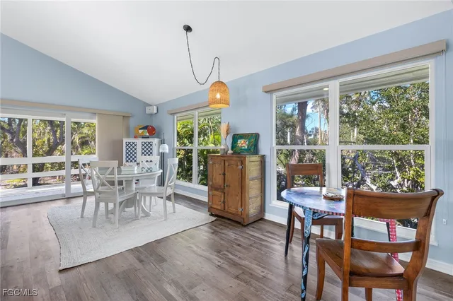 a dining room with furniture a livingroom and wooden floor