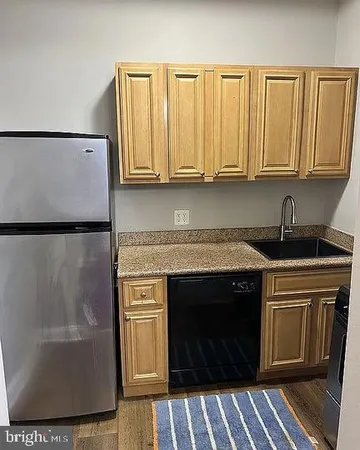 a kitchen with stainless steel appliances granite countertop a stove a microwave and a refrigerator