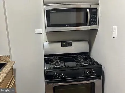 a stove top oven sitting inside of a kitchen