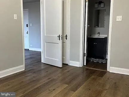 an empty room with wooden floor and closet