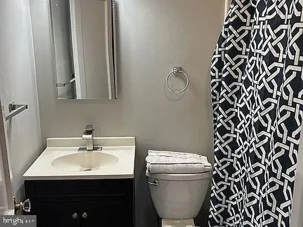 a bathroom with a sink toilet and mirror