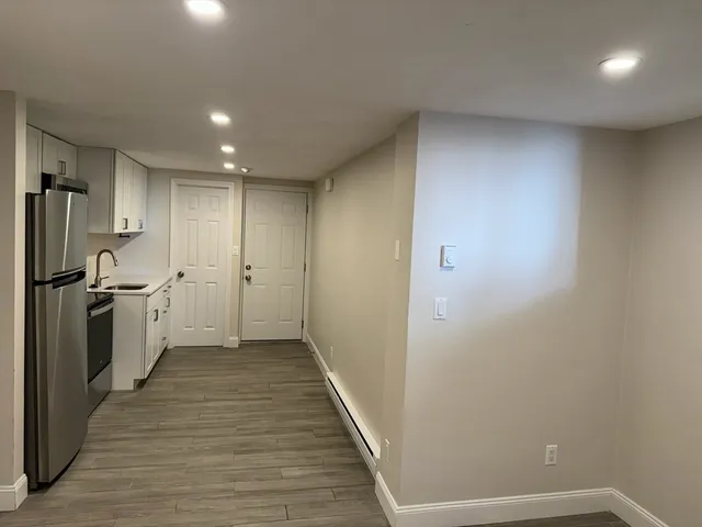 a view of a kitchen with a sink and wooden floor