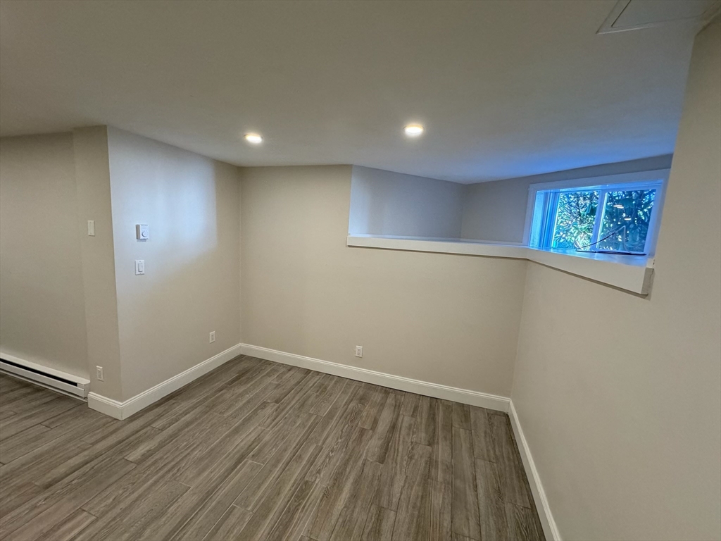 27 Salem Street, Unit 4 Woburn, MA 01801 - Photo 6 of 7 a view of empty room with wooden floor