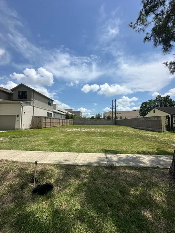 a view of a big yard with table and chairs