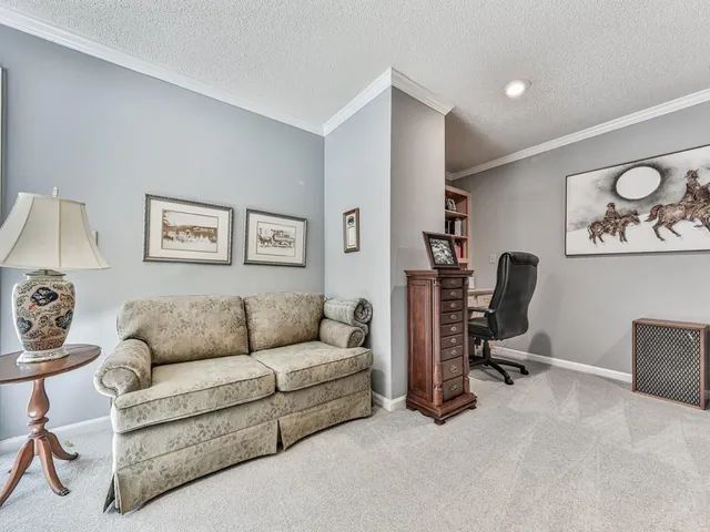a living room with furniture and a cabinet