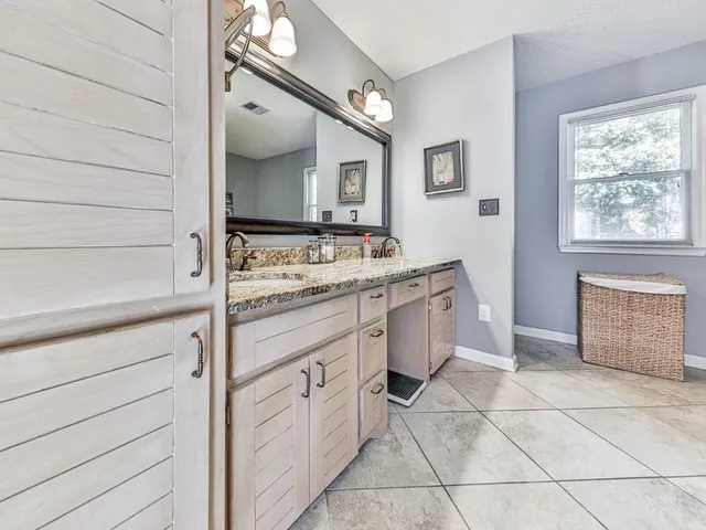 a bath tub sitting next to a bathroom sink