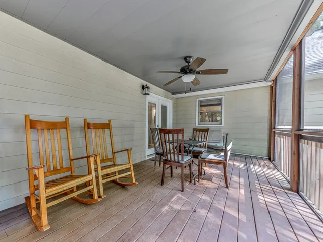 a view of balcony with wooden floor and fence