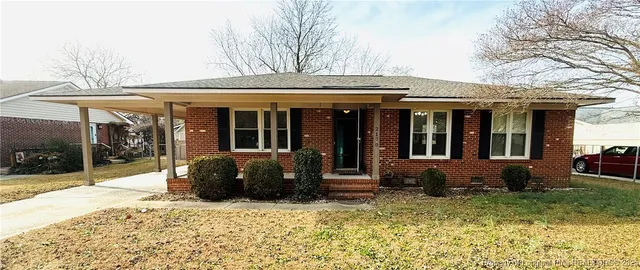 a view of a brick house with large windows